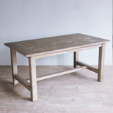 Reclaimed pine wood dining table with mozaic top in a minimalistic room.