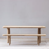 Wooden dining set against a plain white wall