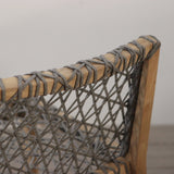 Close-up of a wooden chair with woven backrest on a plain background