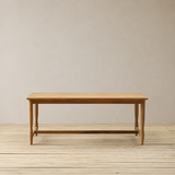 Wooden table on a wooden floor with a plain wall background