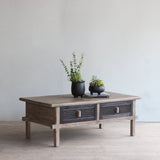 Wooden coffee table with decorative items in a minimalistic room