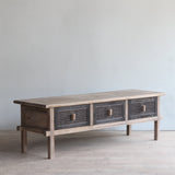 TV Cabinet with three rattan drawers against a plain wall.
