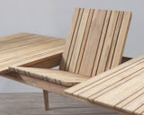 Outdoor extended table with slatted top on a wooden floor