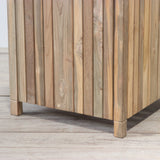 Wooden planter box on a wooden floor against a plain wall