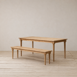 Wooden outdoor dining table and bench set on a wooden floor.