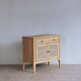 Wooden cabinet with rattan doors in a minimalistic room