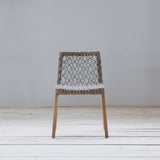 Chair with a geometric pattern on a wooden floor and gray wall background