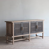 Reclaimed pine wood sideboard with rattan doors in a room setting