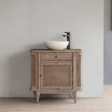 Wooden vanity with a sink against a gray wall