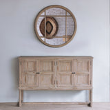 Reclaimed pine wood sideboard against a white wall with round mirror above it
