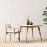 Wooden outdoor dining chair with square dining table set on a wooden floor
