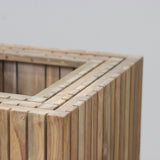 Wooden planter box set against a plain wall