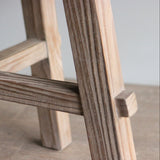 Close-up of a wooden table legs on a neutral background