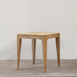 wooden square dining table with slatted top on a wooden floor.