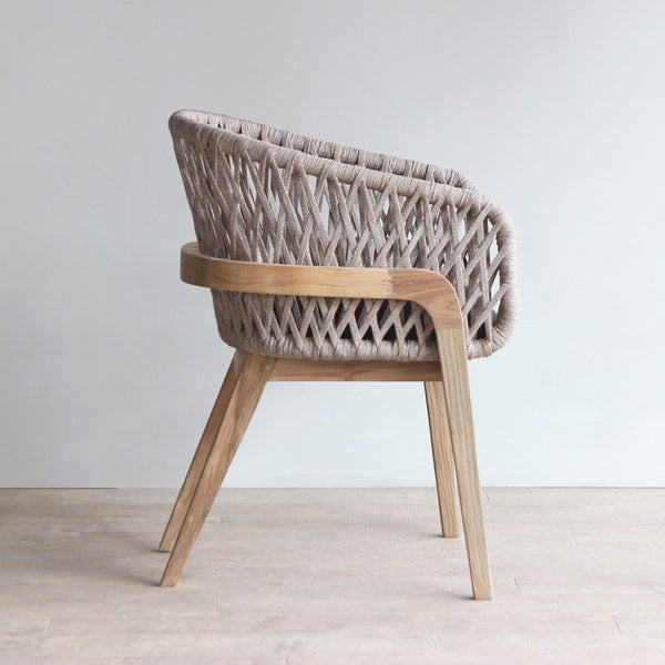 Side view of Arch Dining Chair, showcasing it's silhouette and the woven pattern of the rope backrest.