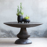 Bali Coffee Table with black decorative plant on top of it.