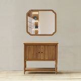 Wooden cabinet with a mirror above it against a plain wall.
