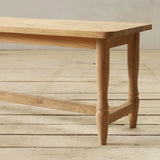 Wooden bench on a wooden floor with a neutral background