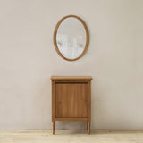 Wooden cabinet and round mirror on a white wall