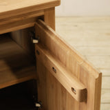 Wooden drawer with open panel on a wooden surface