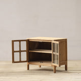 Wooden cabinet with open doors on a wooden floor and light gray wall background
