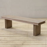 Reclaimed pine wood bench on a wooden floor with a neutral background