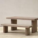 Reclaimed pine wood table and bench set on a wooden floor with a plain background