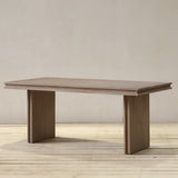 Reclaimed pine wood dining table on a wooden floor with a neutral background