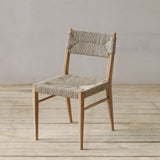 Wooden chair with woven pandan seat and backrest on a wooden floor.