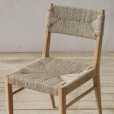 Wooden chair with woven pandan seat and backrest on a wooden floor.