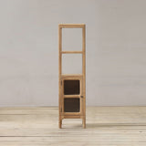Tall wooden bathroom cabinet with shelves against a plain wall.