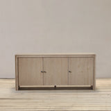 Reclaimed pine wood sideboard with three doors on a wooden floor against a plain wall