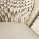 Close-up detail of a woven chair back and seat cushion in a light beige fabric, with a light wood frame visible on the right.
