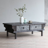 LUNAR Stone Coffee Table with white vase and a cup on top of it.