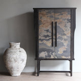 LUNAR Stone Tall Cabinet with blue and tan stone veneer next to a white vase.