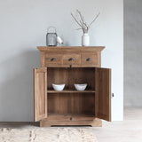 LYON Cabinet with the doors opened. There are two white bowls inside and decoration items on top of it.