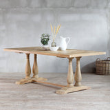 Monarch Dining Table with decoration items on top and wicker basket on the background.
