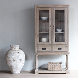 Monarch Glass Cabinet with a vintage white vase next to it.