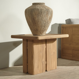 Outdoor wooden end table with a vase on top on a wooden floor