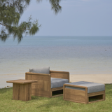 Outdoor wooden sofa 1 seater with end table and a pouf on a grass