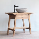 3/4 view of Vanity Bathroom Cabinet with black faucet and stone sink on top of it.