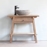 Front view of Vanity Bathroom Cabinet. Displaying black faucet and stone sink on top of it.