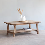 Vanity Coffee Table with white vases on top and books on it.