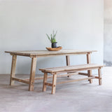 Vanity Dining Table paired with Vanity Bench. There is a wooden bowl and a black planter on top of it.