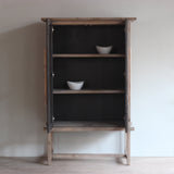 Reclaimed pine wood tall cabinet with open doors on a plain wall background