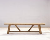 Wooden bench with a minimalist design on a light wooden floor and white background
