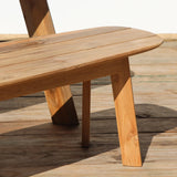 Outdoor wooden dining bench with slatted top on a wooden floor