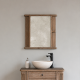Reclaimed pine wood bathroom vanity with wooden mirror, and sink against a gray wall.