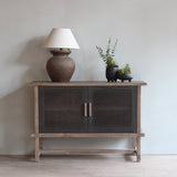 Reclaimed pine wood sideboard with a lamp and plants in a room setting