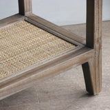 Ratttan lower shelf on a wooden floor
